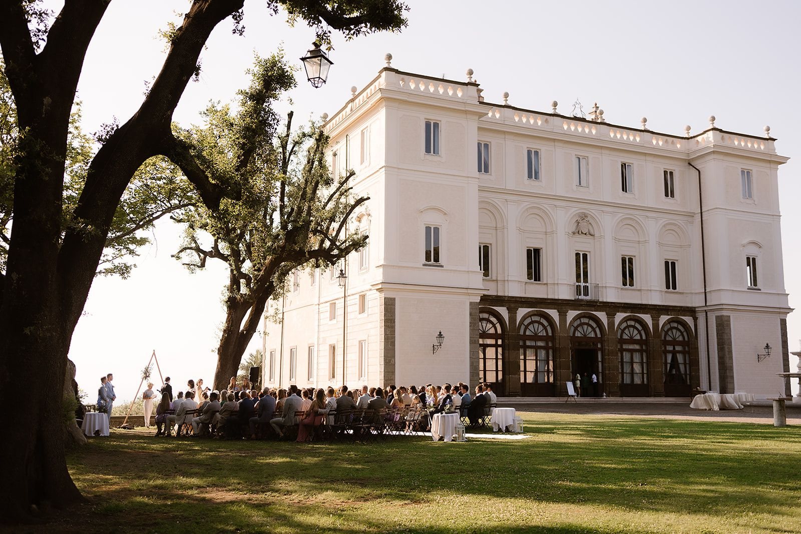 A wedding reception in the gardens of Villa Grazioli at golden hour